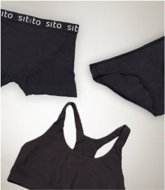 Folded Sito organic cotton clothing in natural tones